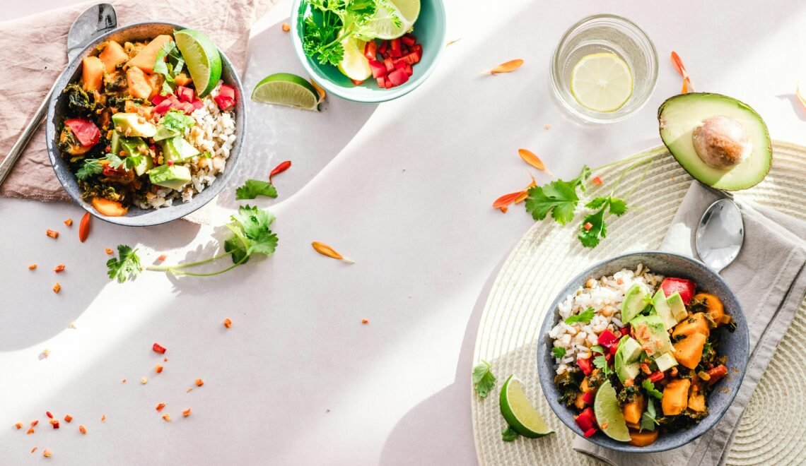 Top-down view of vibrant vegan bowls filled with fresh vegetables, perfect for a healthy meal.